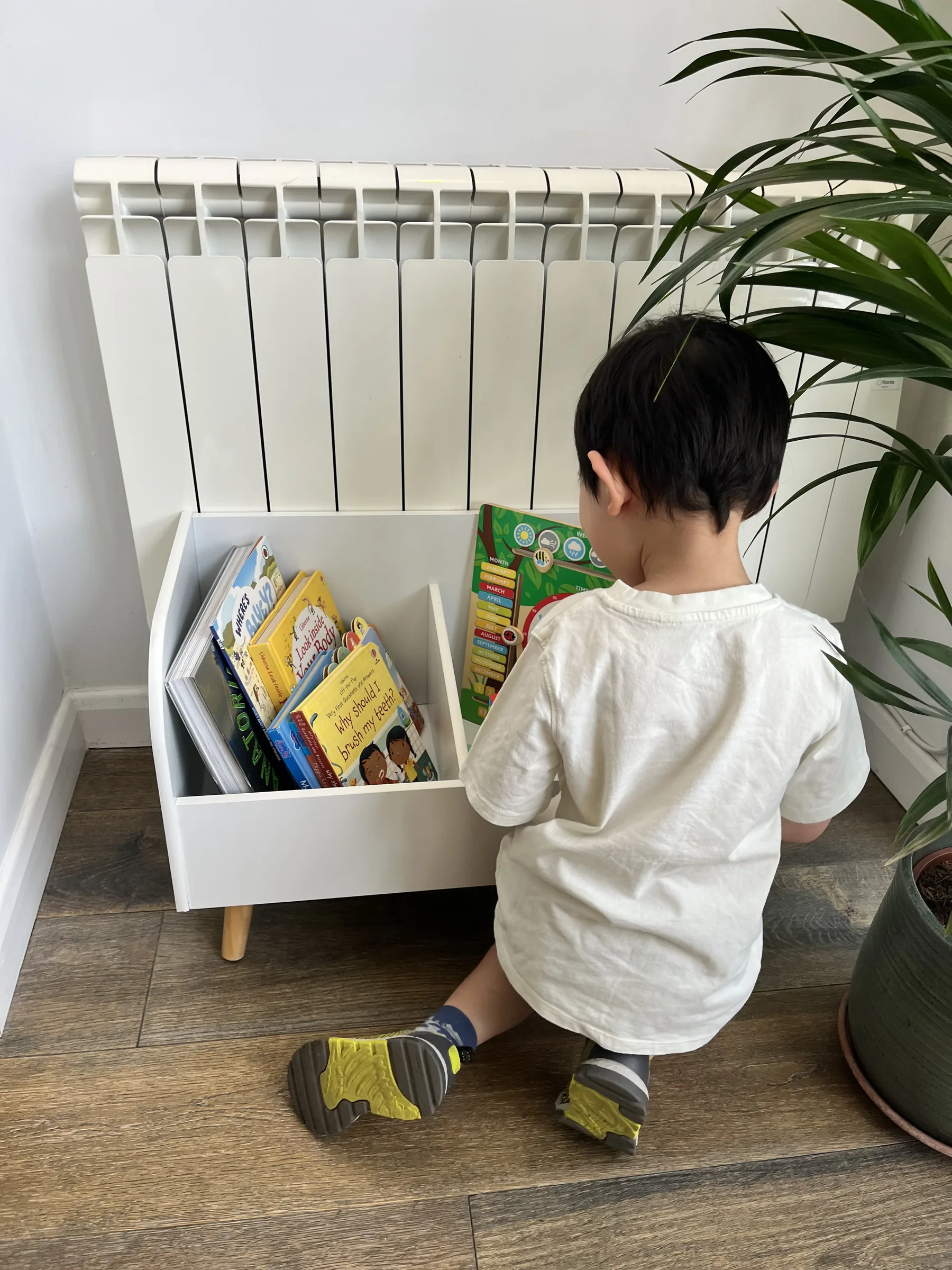 Child choosing a book in the clinic's waiting area