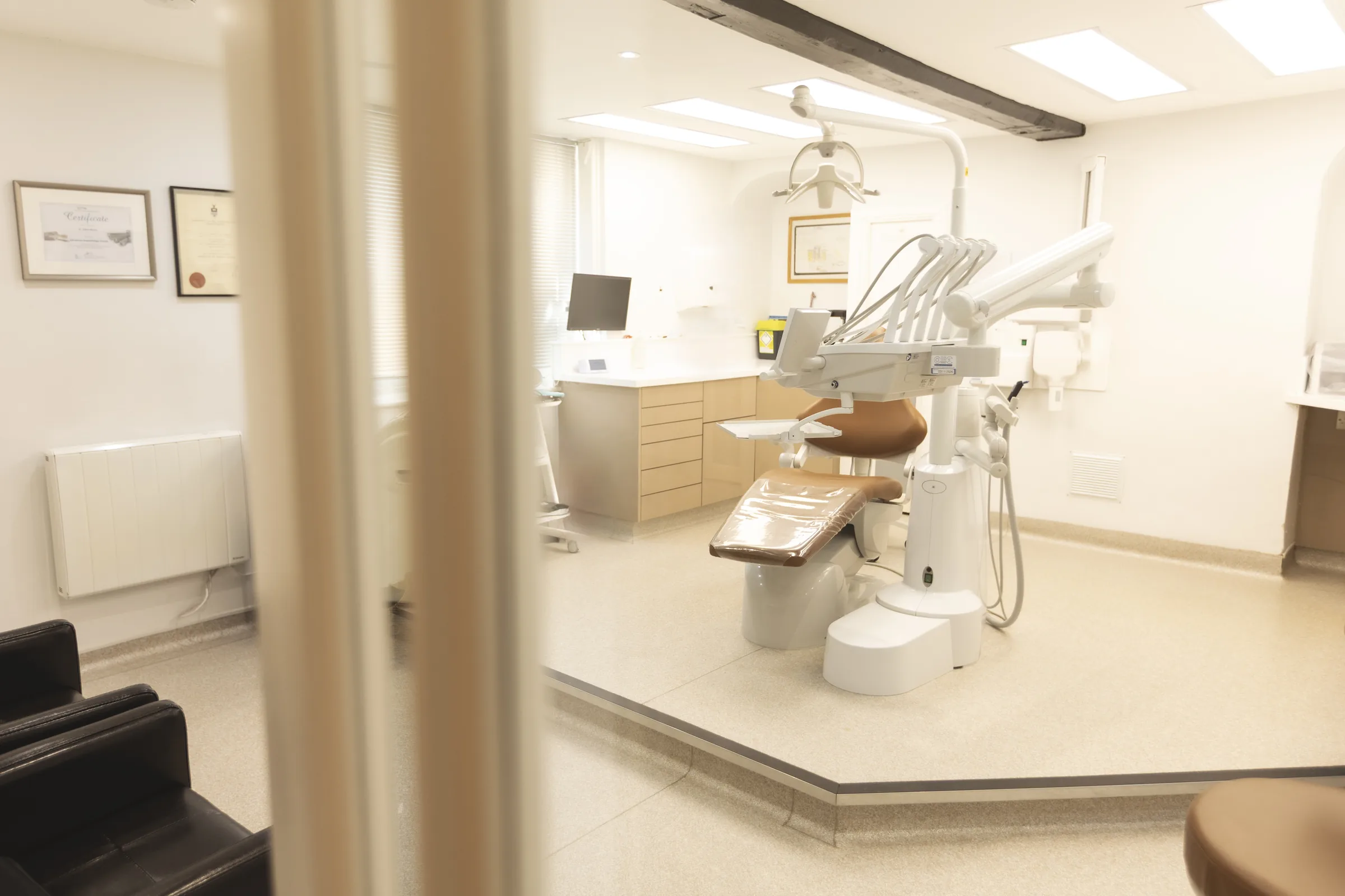 Dentist speaking with a patient in a modern treatment room